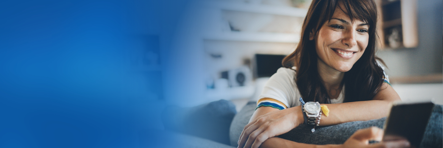 Woman with watch smiling at her phone